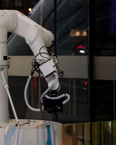 A white robotic arm operating indoors with a modern design and advanced technology.